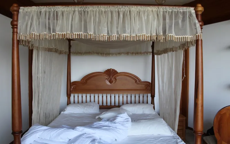 Cozy bohemian bedroom with layered bedding, warm lighting, and natural textures