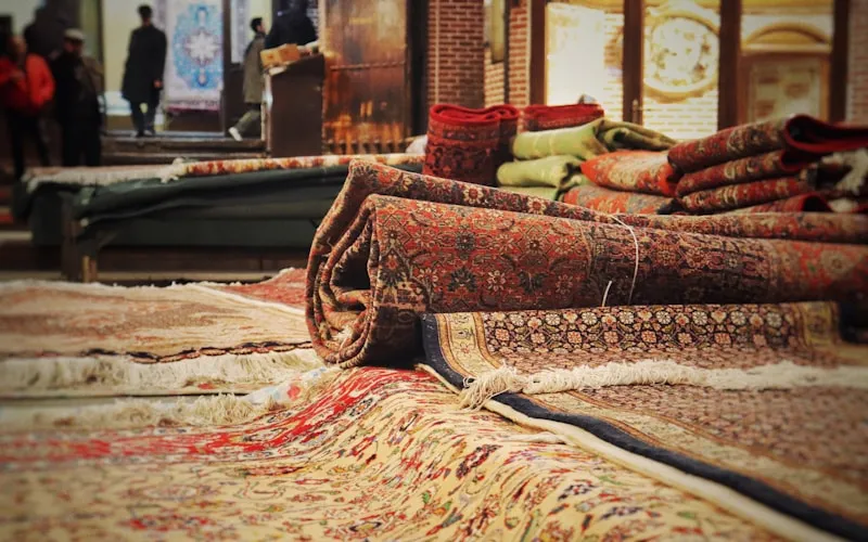 Bohemian living room layered with colorful textiles, patterned rugs, and floor cushions