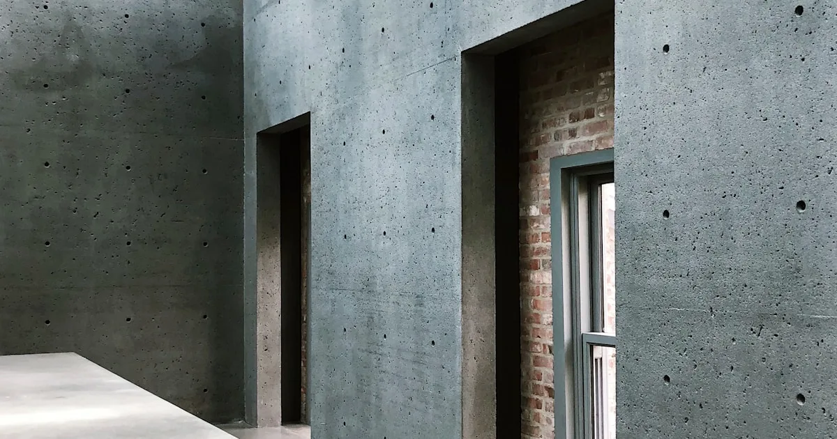 Brutalist interior with raw concrete walls and bold furniture