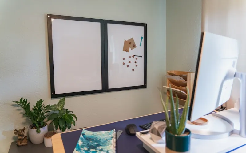 Interior design studio workspace with mood boards and fabric samples