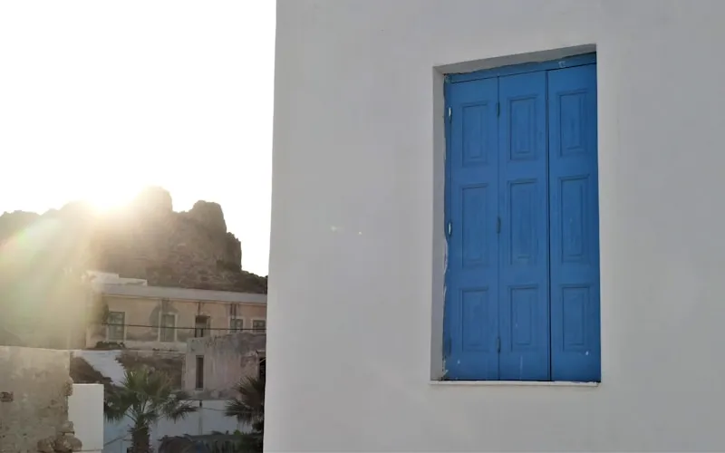 White-washed Greek interior with blue accents and characteristic arched doorways