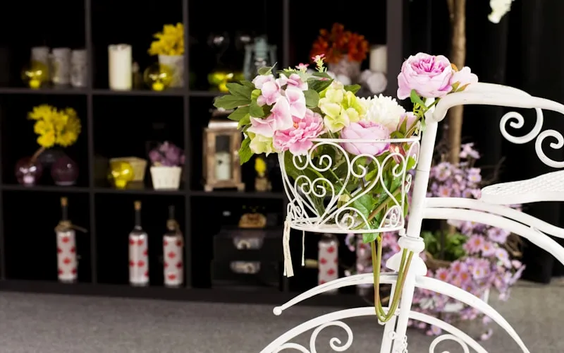 Interior styling accessories including curated vases, books, and fresh flowers