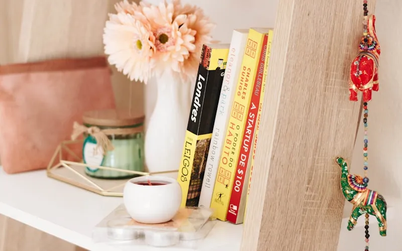 Stylish home office with bookshelf, plants, and warm personal touches