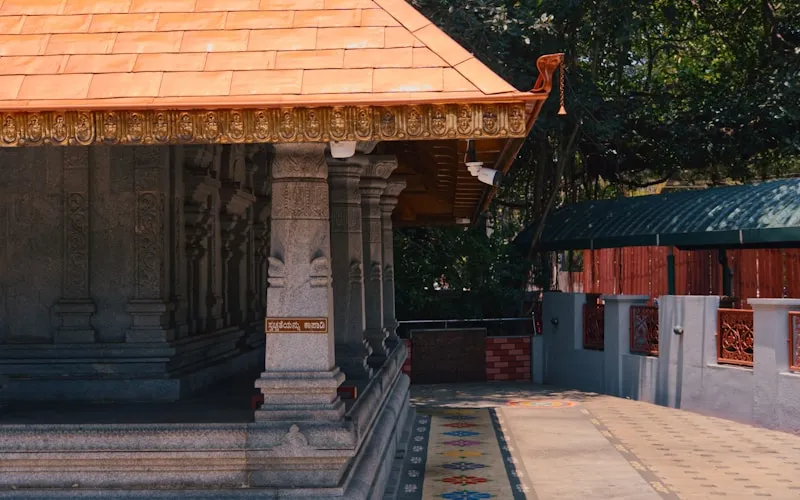 Modern mandir design with carved wooden details and warm lighting