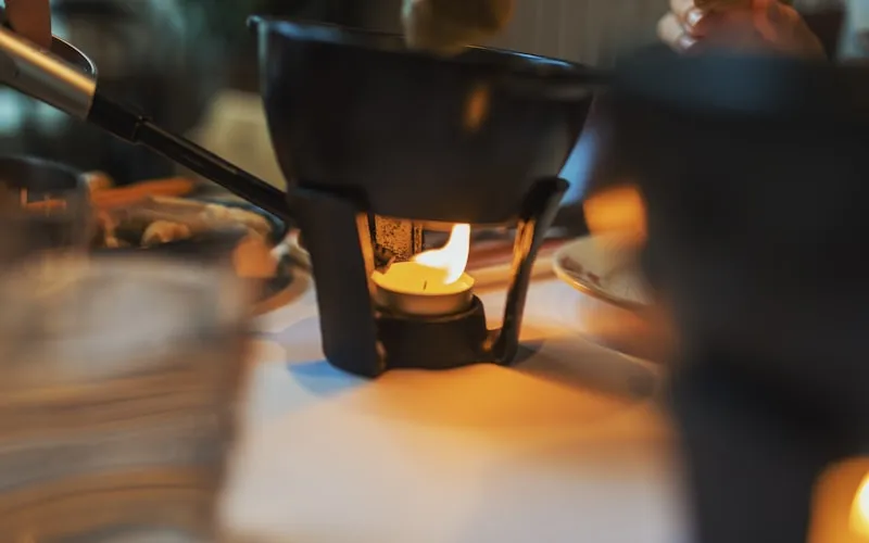 Intimate restaurant atmosphere with warm candlelight and rich textures