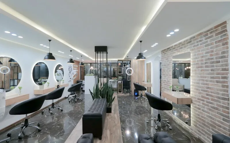 Modern beauty salon with elegant styling stations and ambient lighting