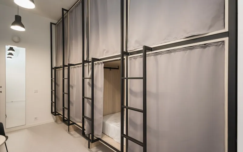 Vertical wall shelving and storage maximizing space in a small living room