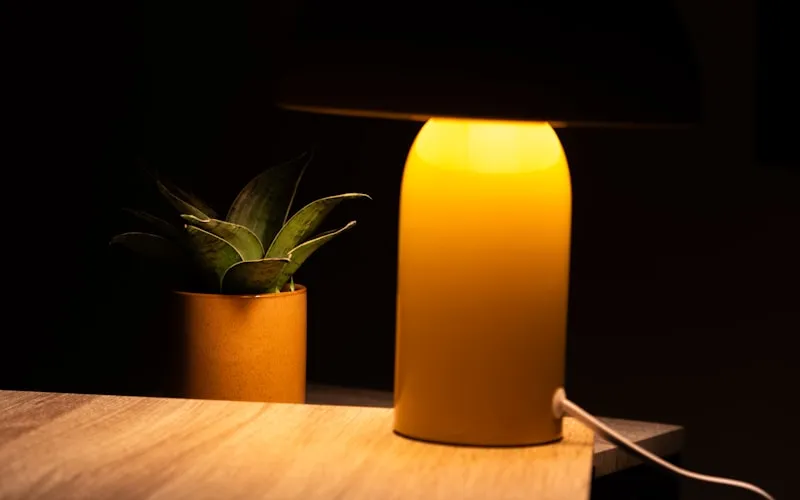 Warm ambient lighting with table lamps and candles creating a golden glow