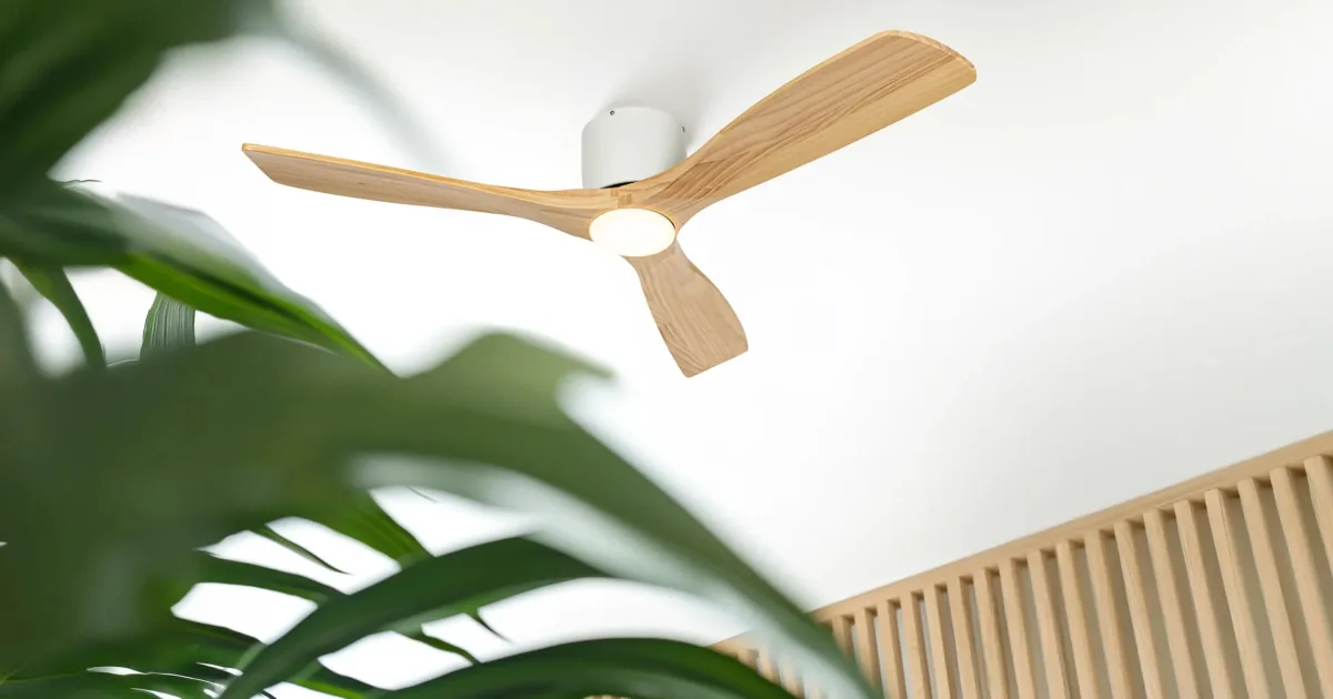 Wooden blade ceiling fan with a natural timber finish mounted on a pale ceiling